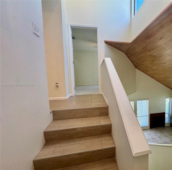 Stairway featuring a skylight
