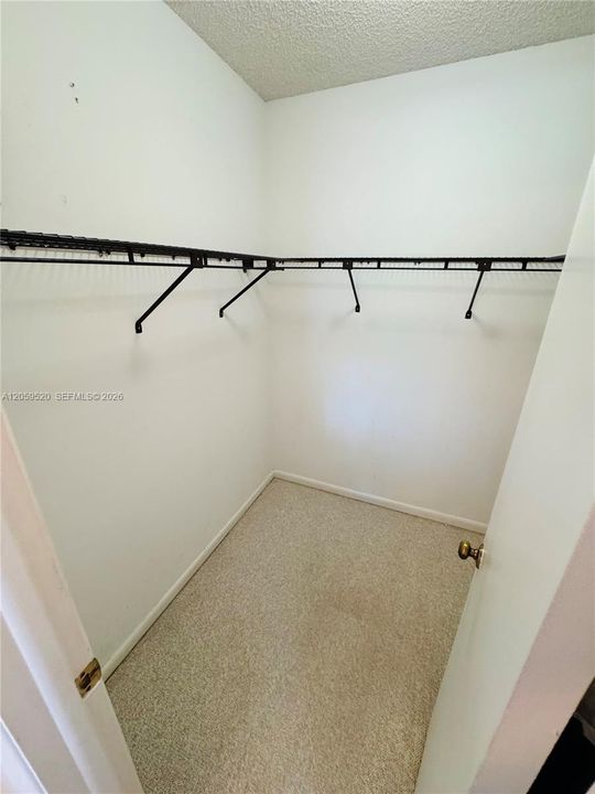 Primary bedroom with a large walk in closet