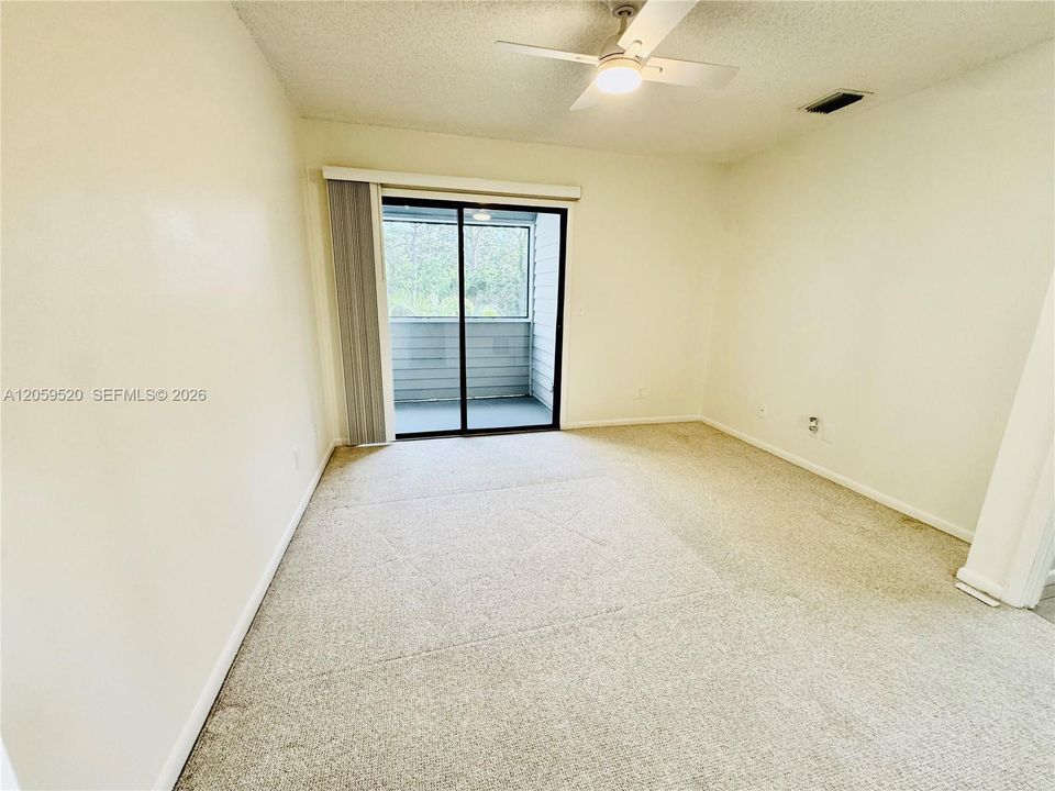 Primary bedroom with a private balcony and large walk in closet