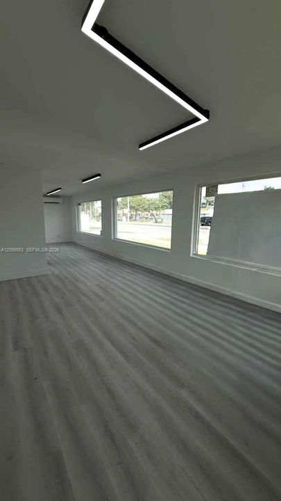 Bright open office with large storefront windows and natural light