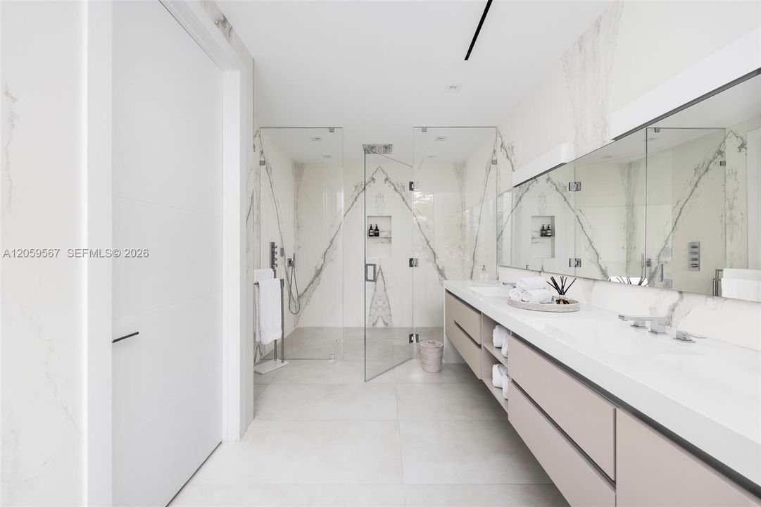 Primary bathroom with dual sink and spacious shower area