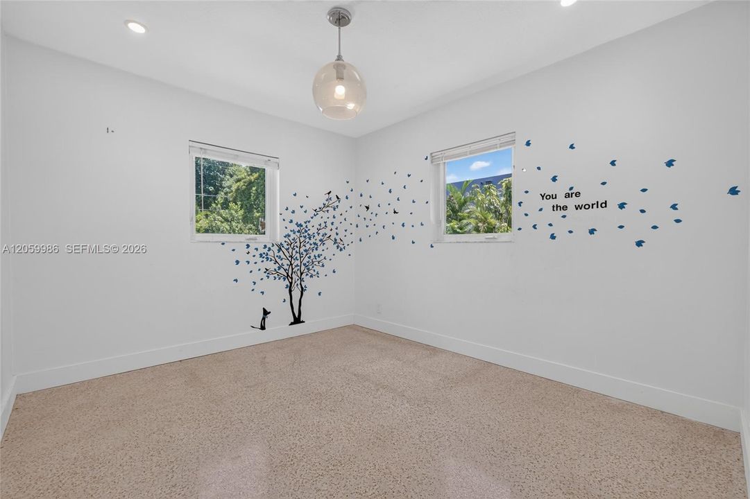 Secondary bedroom with the original terrazo flooring