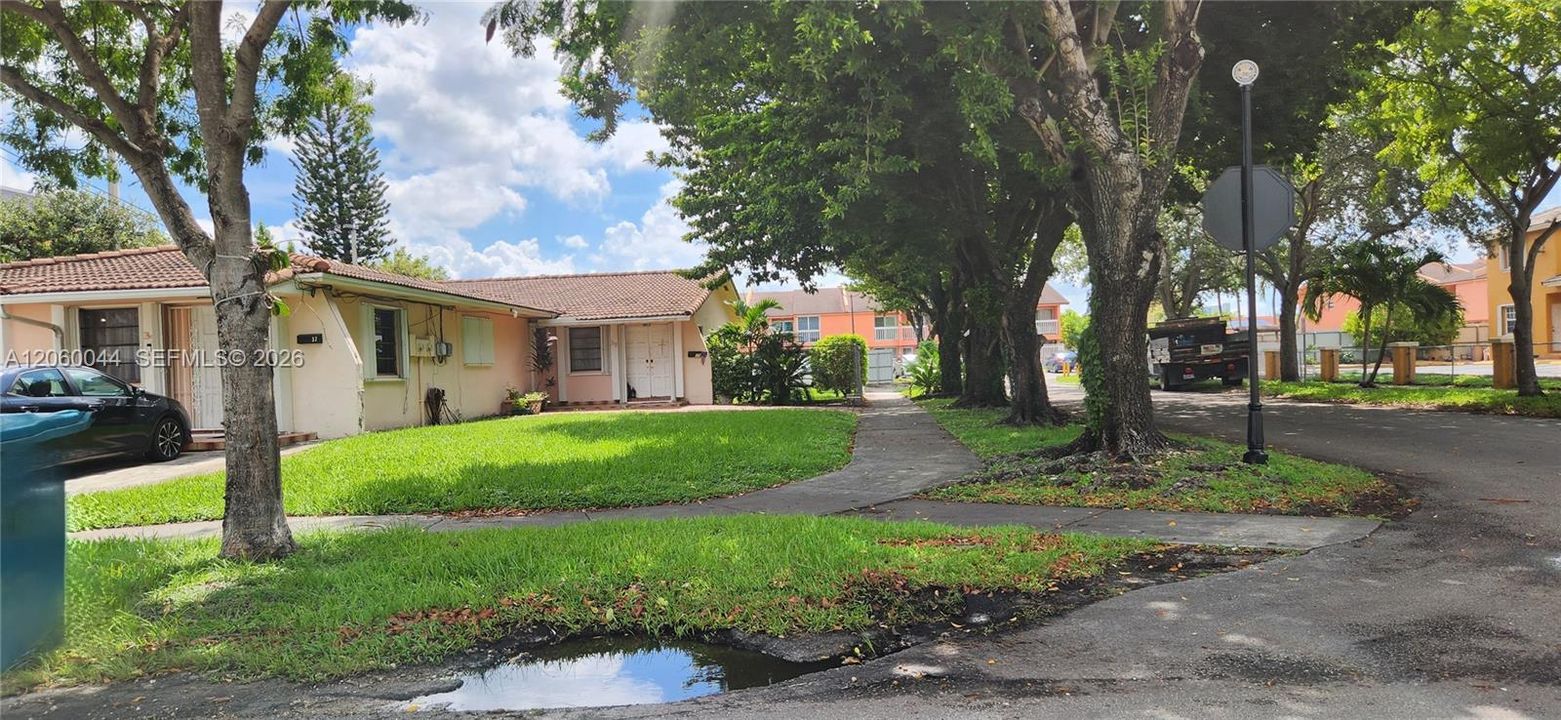 Well-maintained corner duplex featuring mature street landscaping & spacious outdoor grounds on an expansive 11,270 SF lot.