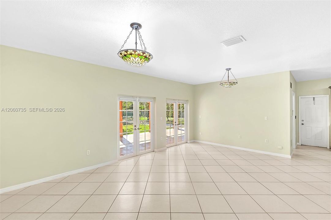 This family room is perfect for entertaining, it opens to an expansive covered terrace and backyard.