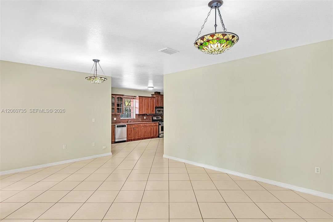 This family room is perfect for entertaining, it opens to an expansive covered terrace and backyard.