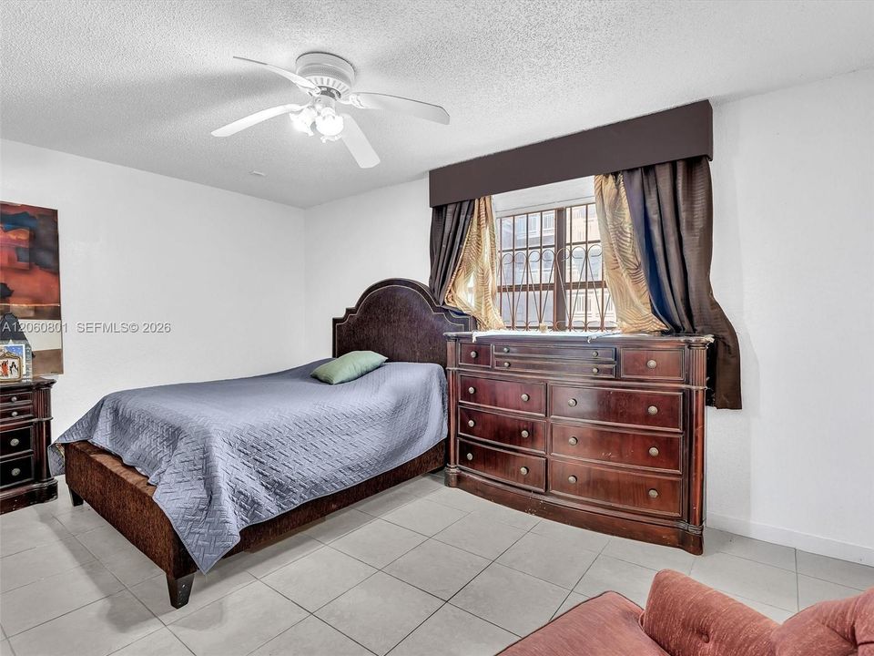 Primary bedroom with tile flooring