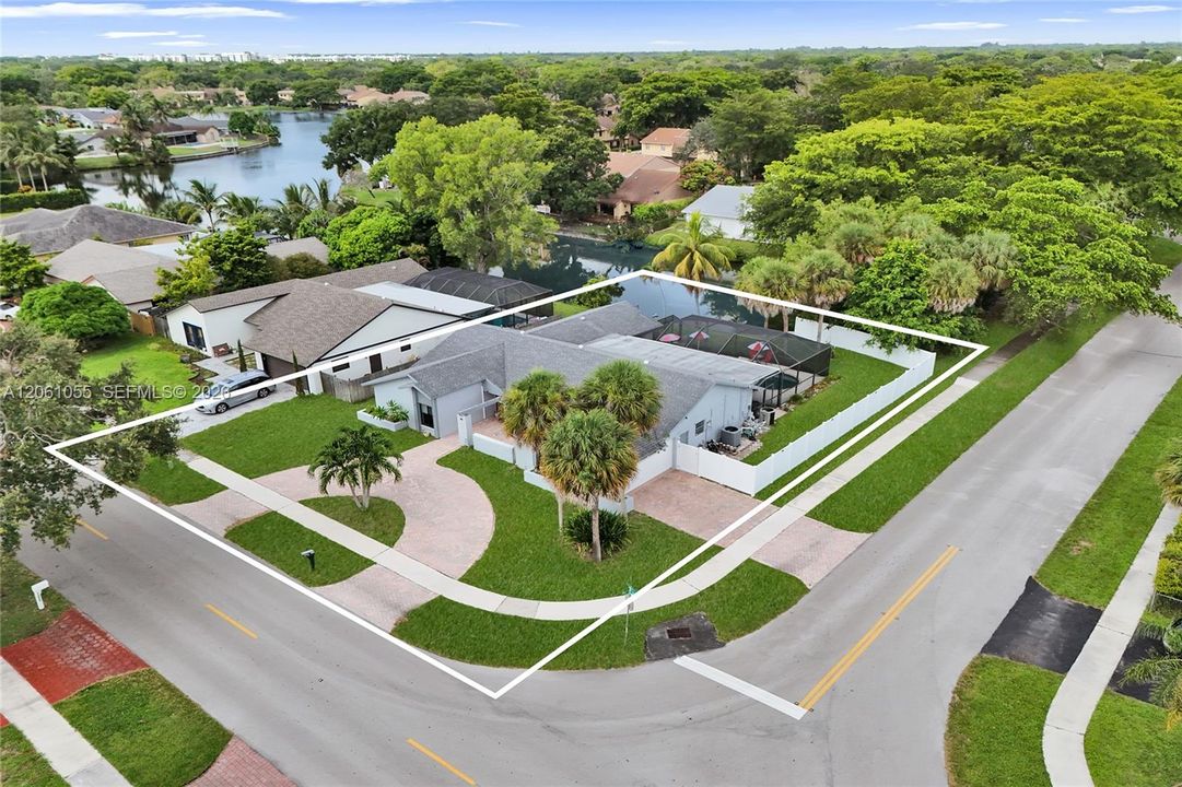 Corner lot wit pool, lake view and two driveways