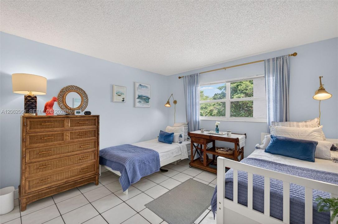 Second bedroom features two twin beds and a walk-in closet.