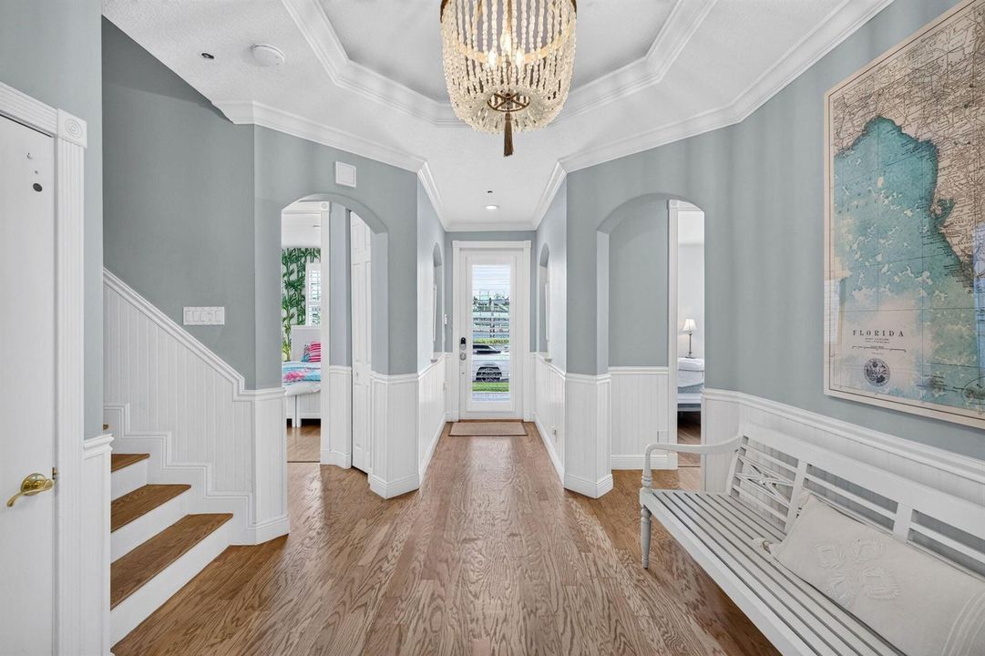 Foyer with high ceilings and wainscoting