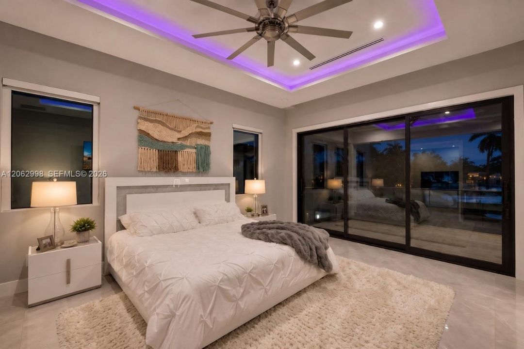 Primary bedroom suite w/ french doors, morning bar, en suite walk in closet and spa bathroom. Sliders lead to private balcony looking down the river