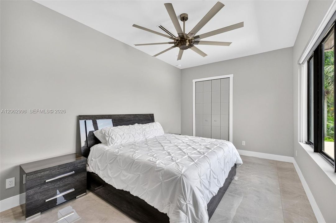 Primary bedroom suite w/ french doors, morning bar, en suite walk in closet and spa bathroom. Sliders lead to private balcony looking down the river