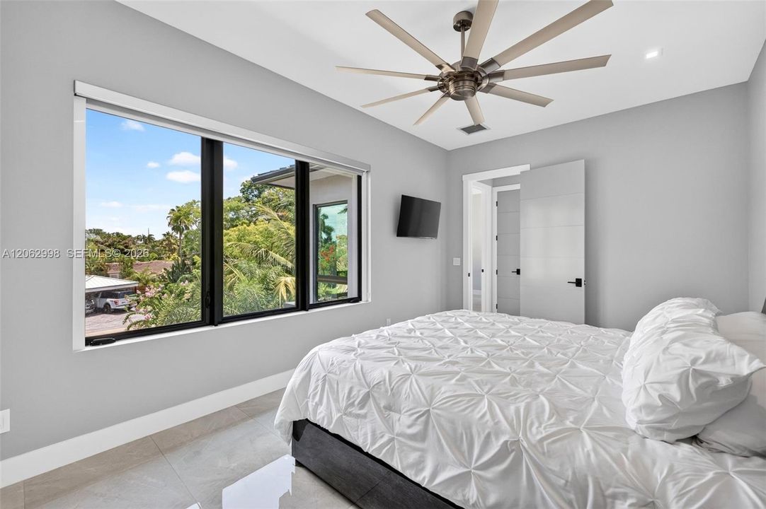 Primary bedroom suite w/ french doors, morning bar, en suite walk in closet and spa bathroom. Sliders lead to private balcony looking down the river