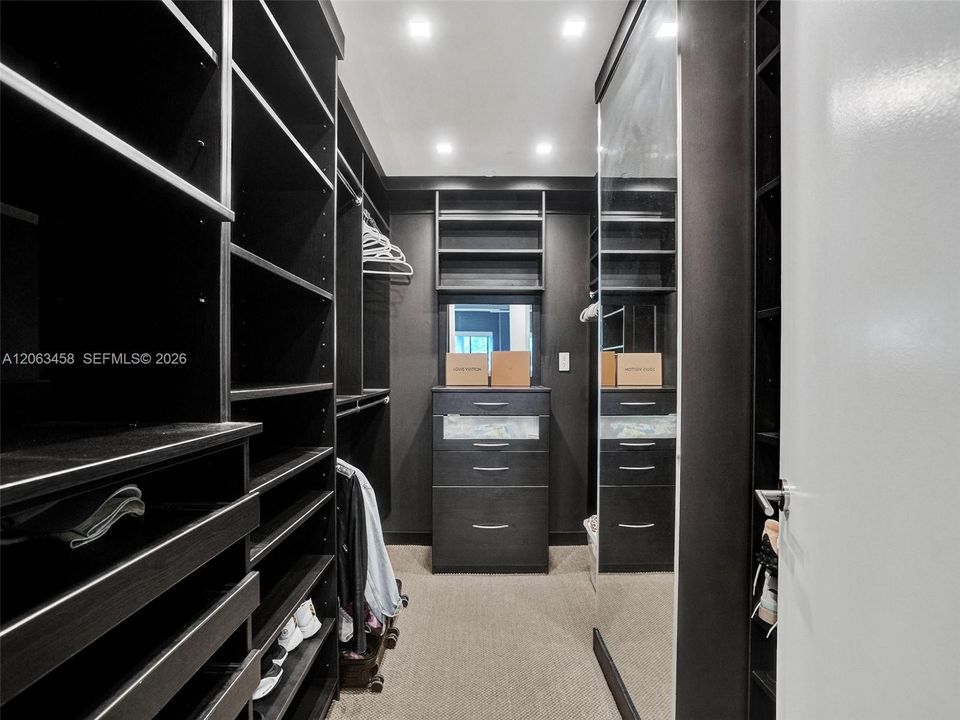 Primary bedroom walk-in closet