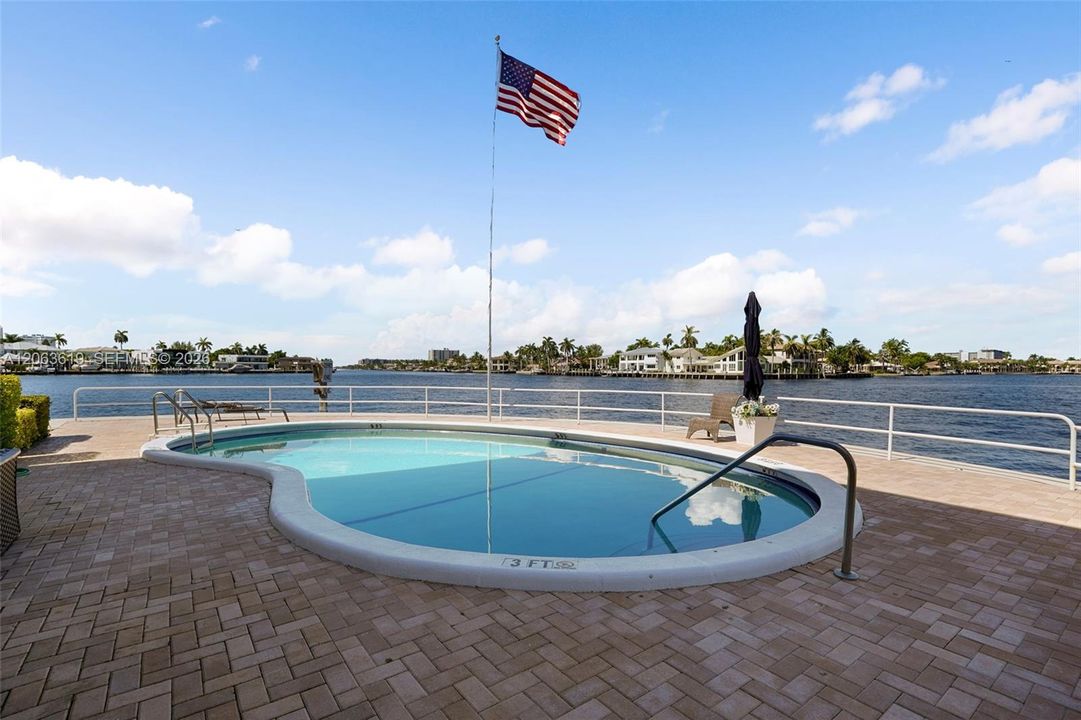 Relax by the waterfront pool.