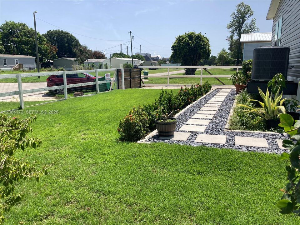 The front yard and driveway is fenced and gated