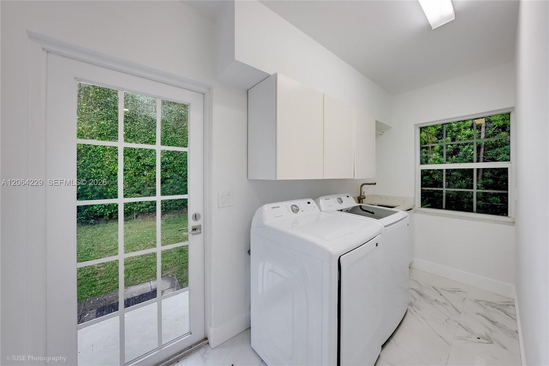 Laundry room next to the kitchen, new washer & dryer