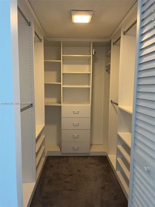 Spacious walk in closet in master bedroom.
