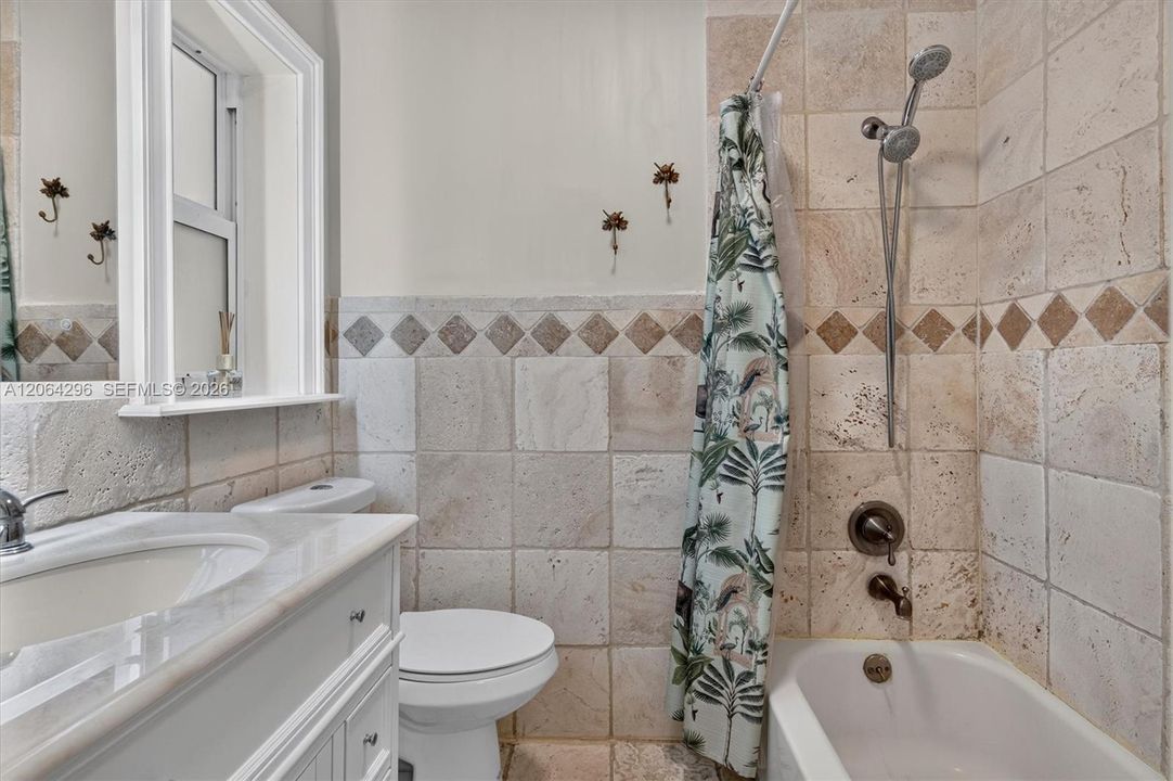 Updated primary bathroom with modern fixtures and finishes.