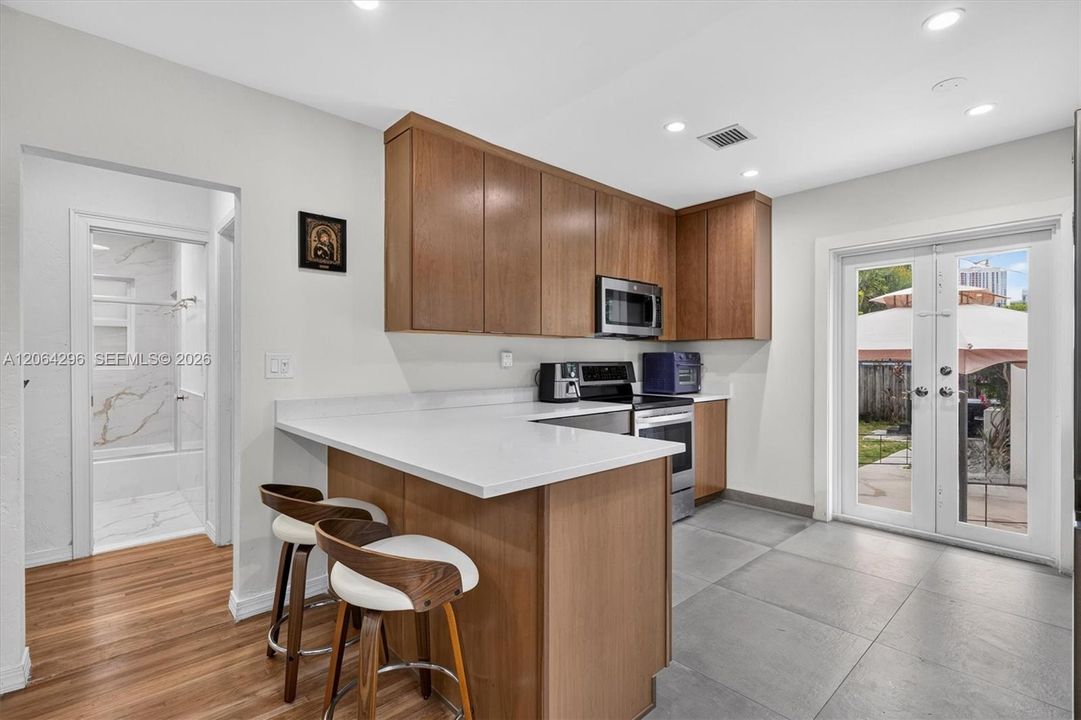 Quartz countertops and abundant workspace in the updated kitchen.