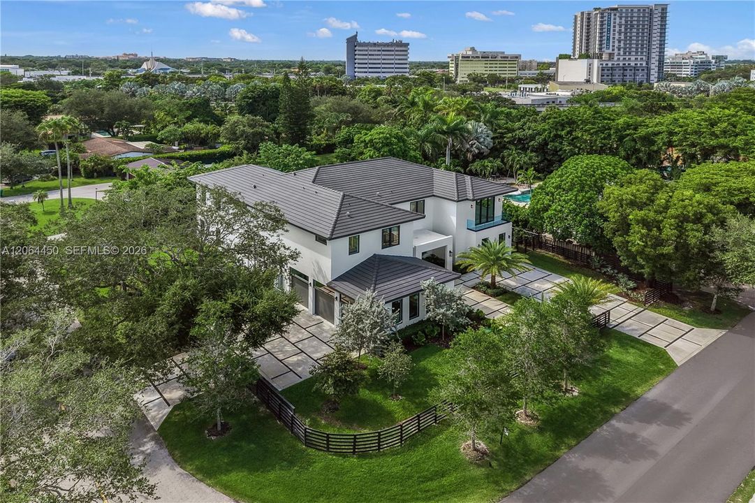 Elevated aerial perspective of the home with the city skyline in the distance