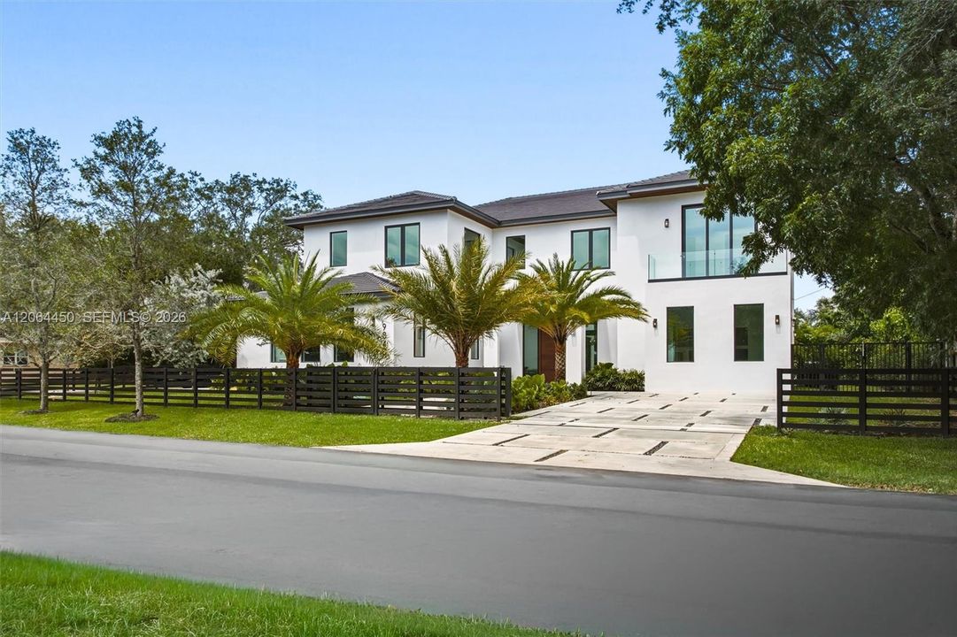 Ample driveway to park up to 9 cars in both sides plus an air conditioning garage for 3 additional car and space for a car lift.