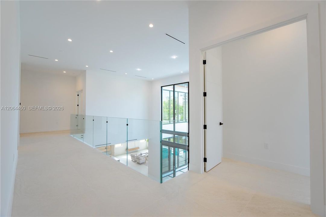 Staircase landing with glass railing