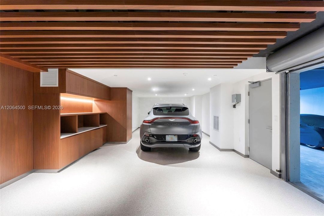 Private air-conditioned garage accommodating 2 cars, plus 3 additional side-by-side parking spaces included with the unit.