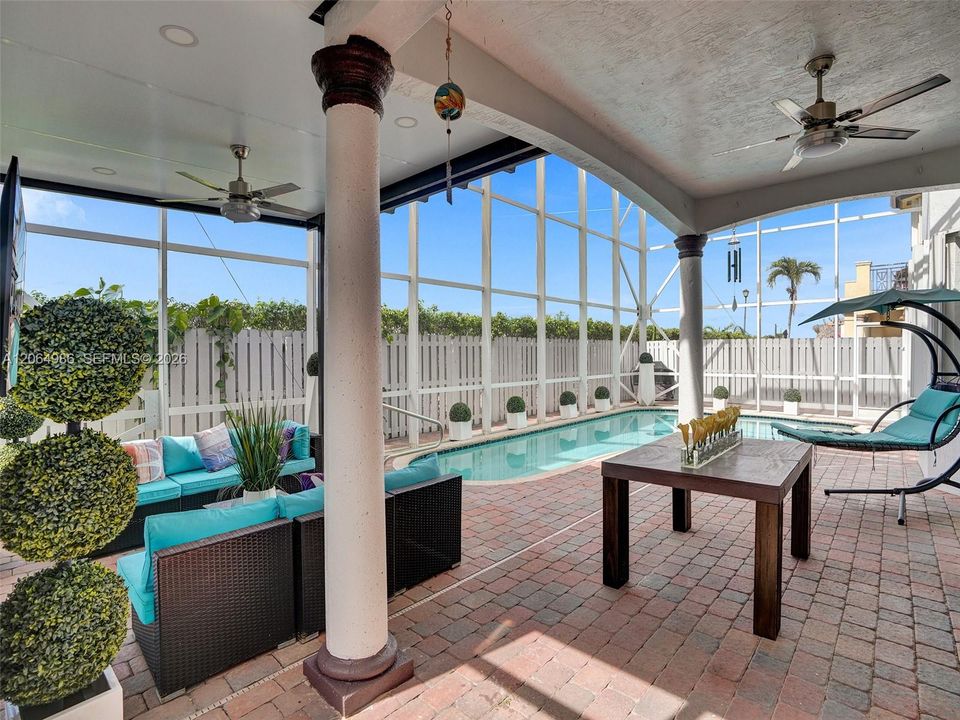 SCREENED COVERED TERRACE IN POOL AREA WITH CEILING FANS, LIGHTS AND TV HOOK-UP