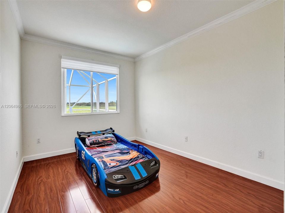 UPSTAIRS THIRD BEDROOM OVERLOOKING POOL AND FIELD AREA.
