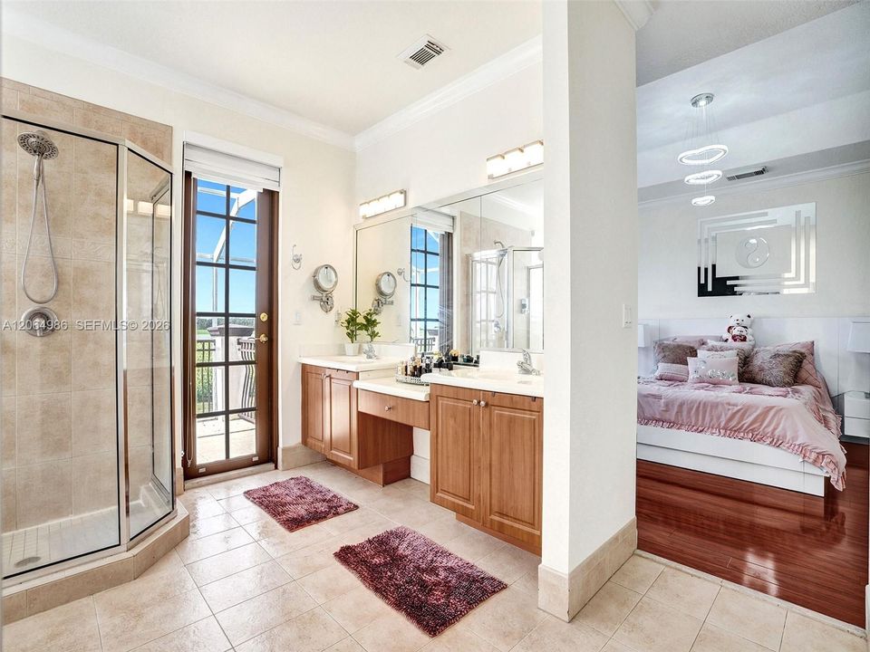 PARTIAL VIEW OF MASTER BATHROOM WITH FRENCH DOOR LEADING TO BALCONY WHERE YOU CAN ENJOY ROMANTIC SUNSETS BEHIND CORN FIELD.