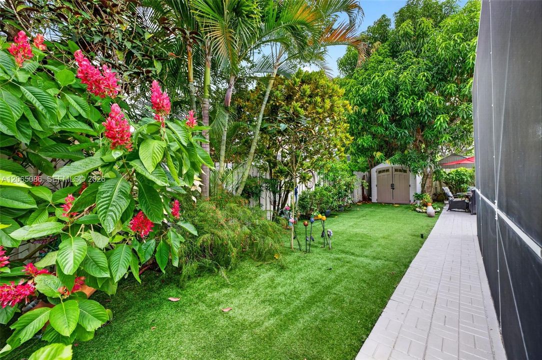 Step outside to your large, fully tiled, screened-in patio with a covered overhang overlooking a fully fenced backyard with mature fruit trees, astroturf and a Rain Bird irrigation system.