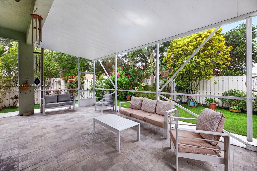 Step outside to your large, fully tiled, screened-in patio with a covered overhang overlooking a fully fenced backyard with mature fruit trees and a Rain Bird irrigation system.