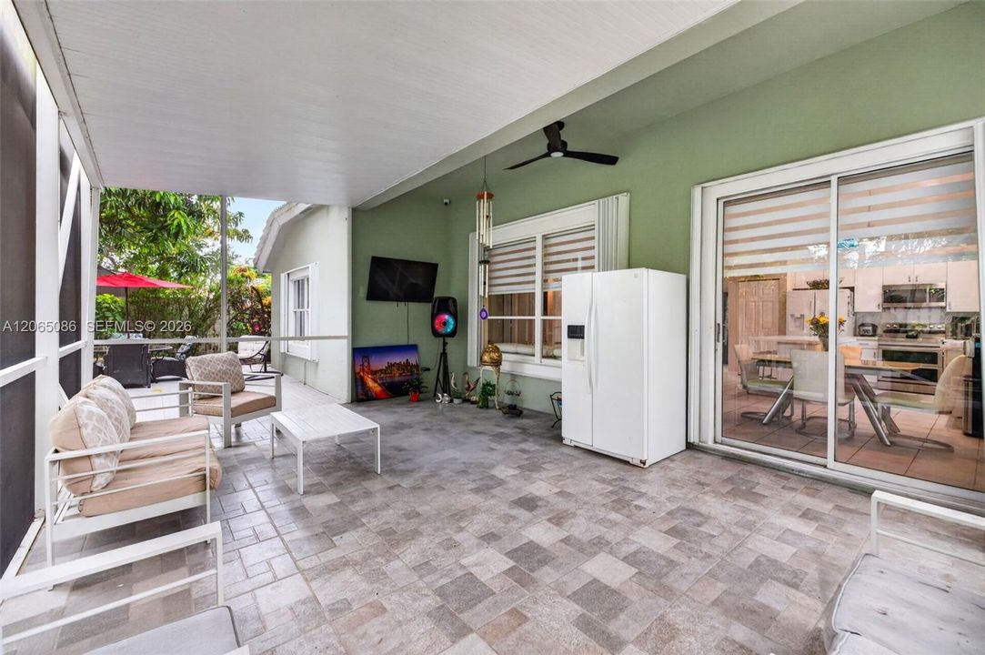 Step outside to your large, fully tiled, screened-in patio with a covered overhang overlooking a fully fenced backyard with mature fruit trees, astroturf and a Rain Bird irrigation system.