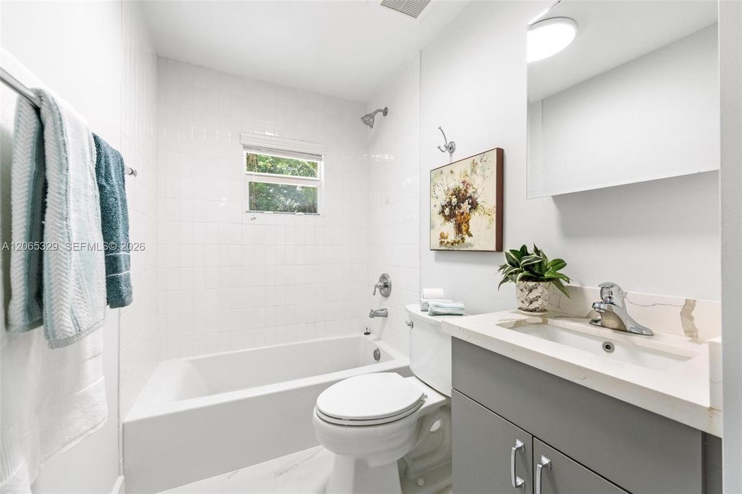 The first bathroom keeps the palette clean, simple, and timeless.