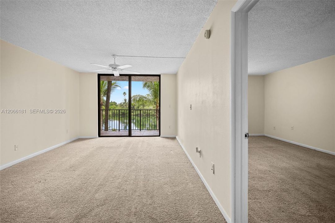 View towards living room, balcony, lake and part of the bedroom