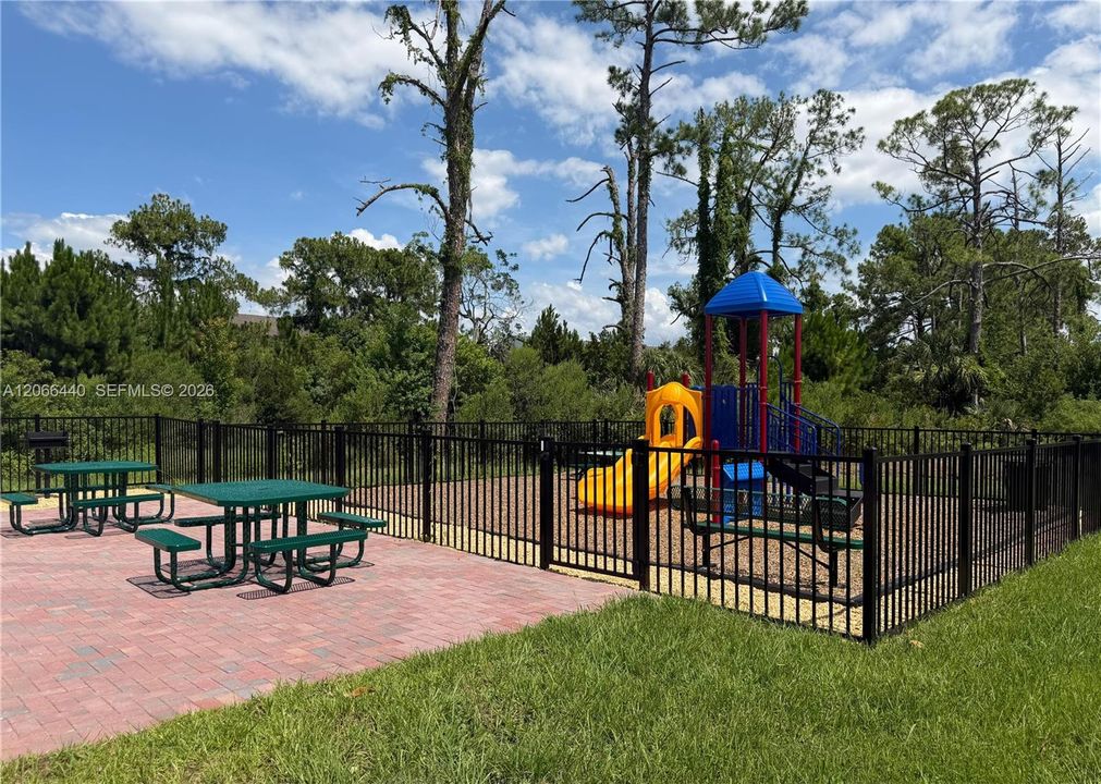 Playground with seating area for residents’ comfort and convenience.