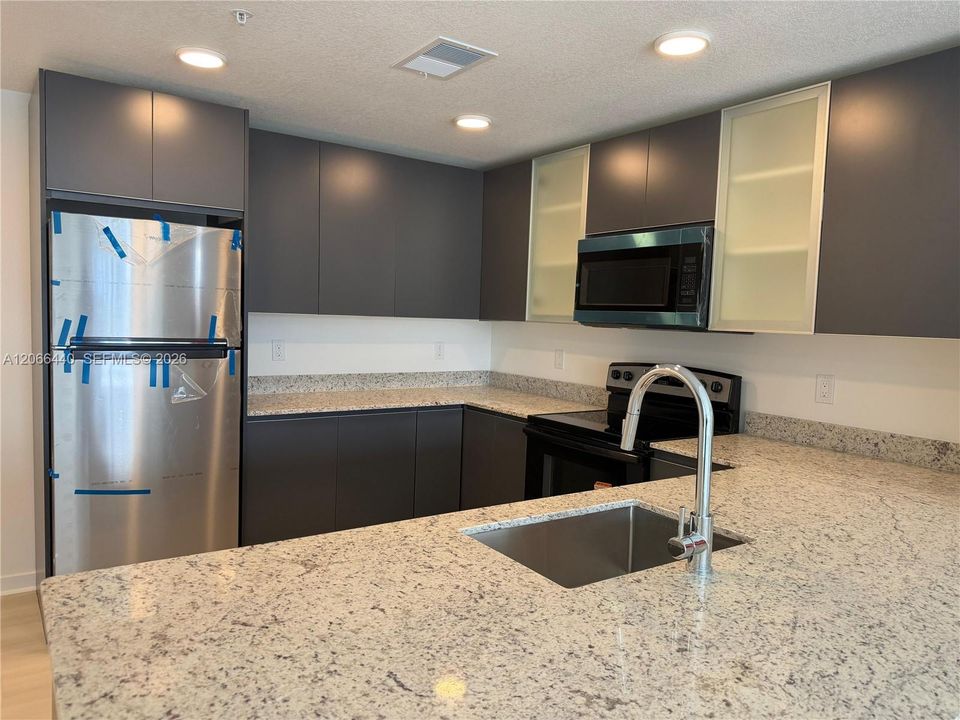 Full Equipped Kitchen - Modern new construction featuring brand-new appliances throughout.