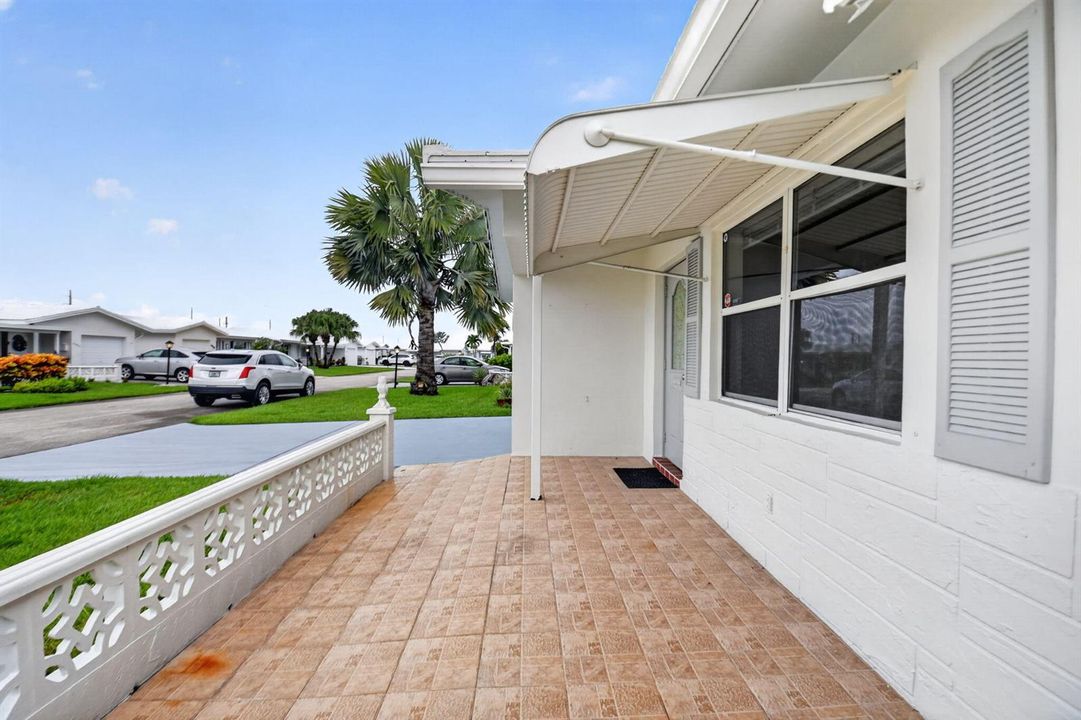 Tiled front porch/ New glass/Shutters