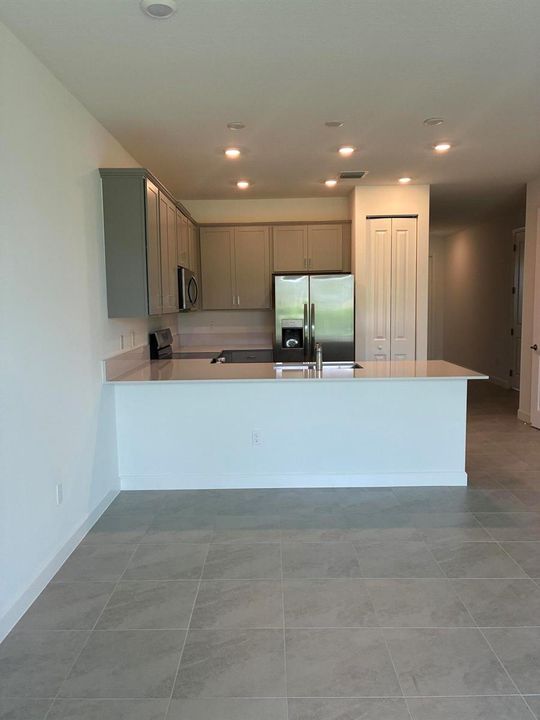 Tile living room view of Kitchen
