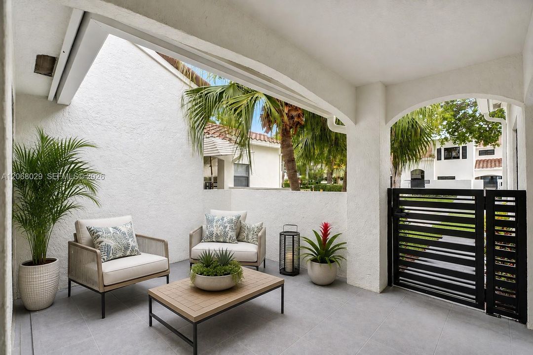 Florida outdoor living in the front courtyard. Virtually staged.