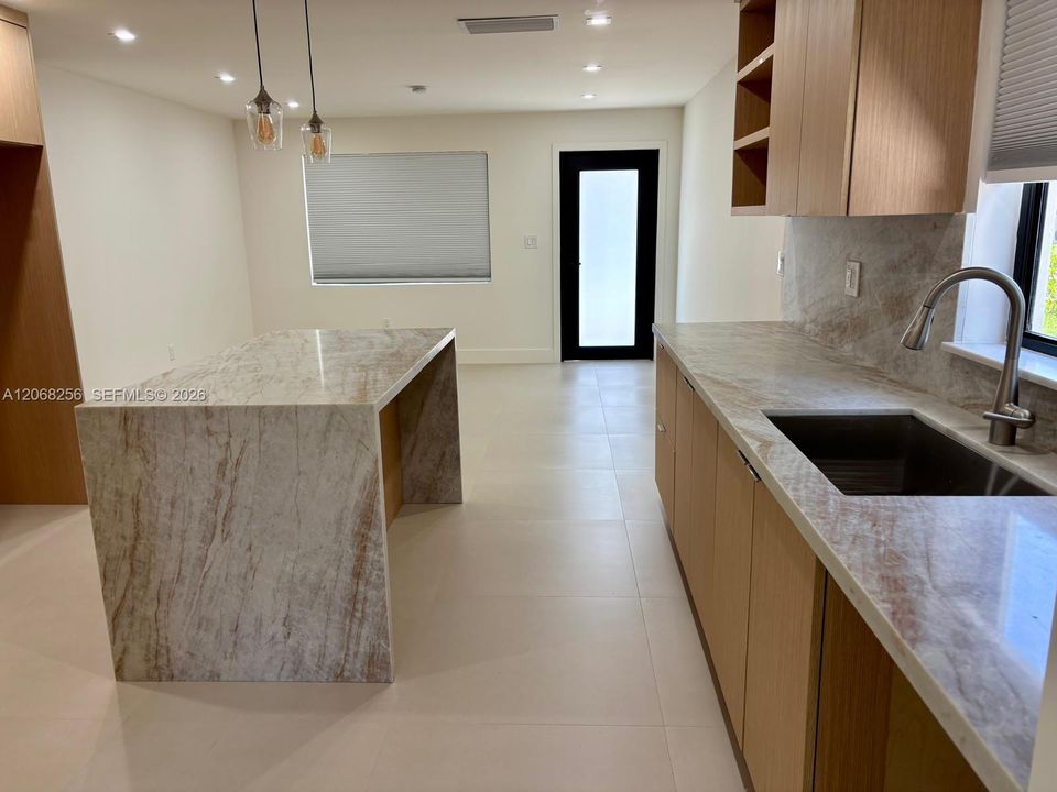Kitchen view of living room and front door