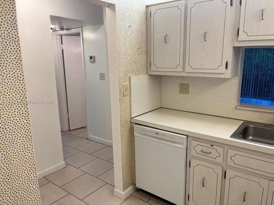 Kitchen with has new dishwasher.