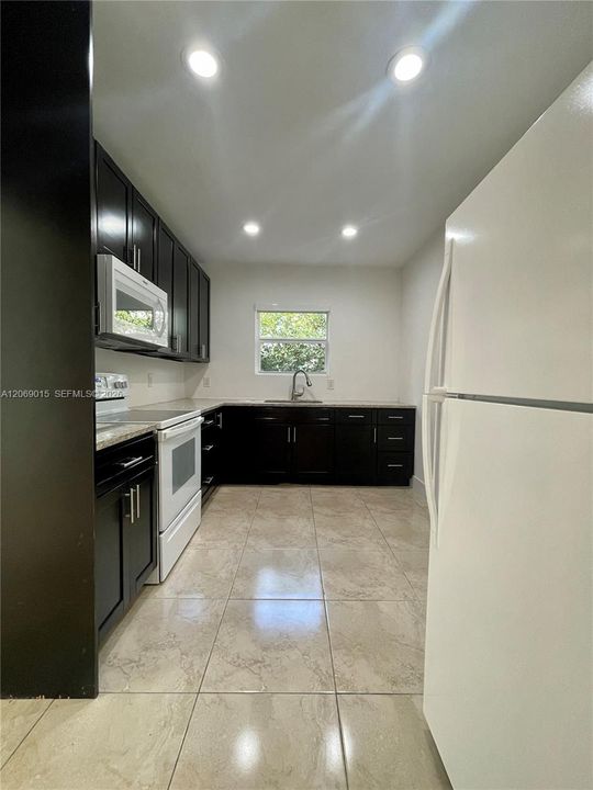 Remodeled kitchen with granite countertops and new cabinets.