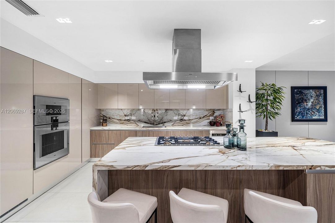 A sophisticated Italian-designed kitchen featuring custom cabinetry, premium Gaggenau appliances, gas cooking and an elegant island ideal for entertaining.