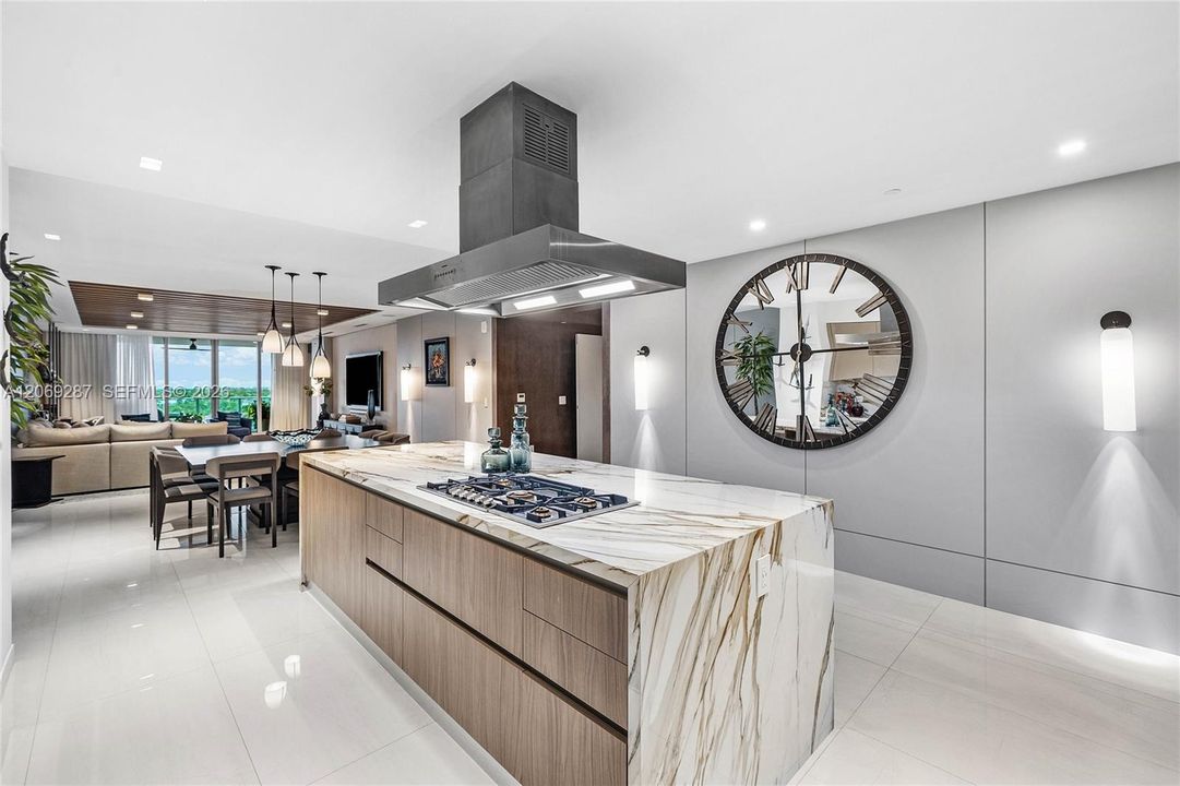 A sophisticated Italian-designed kitchen featuring custom cabinetry, premium Gaggenau appliances, gas cooking and an elegant island ideal for entertaining.