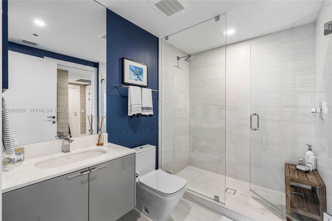 A beautifully appointed second bedroom with a private en-suite bathroom