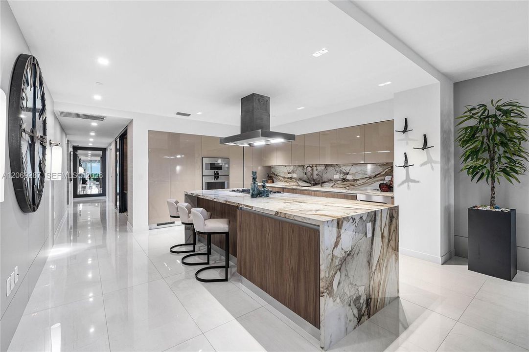 A sophisticated Italian-designed kitchen featuring custom cabinetry, premium Gaggenau appliances, gas cooking and an elegant island ideal for entertaining.