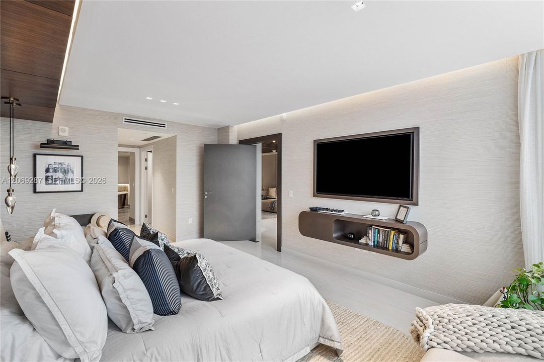 The primary suite is privately positioned at the opposite end of the residence, separate from the additional bedrooms.