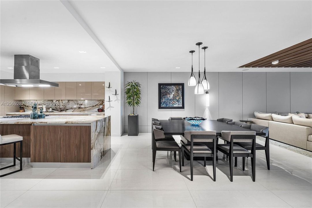 An elegant dining area  offering beautiful waterfront views and a seamless setting for entertaining.