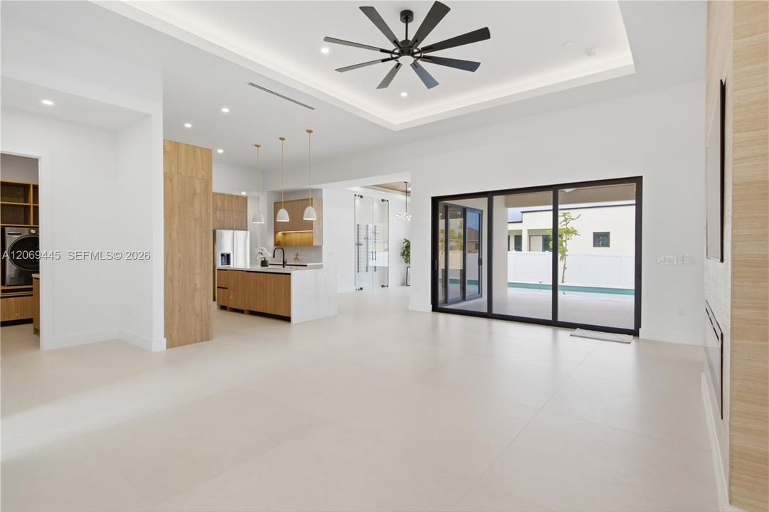 Oversized sliding glass doors provide abundant natural light and seamless access to the pool area.